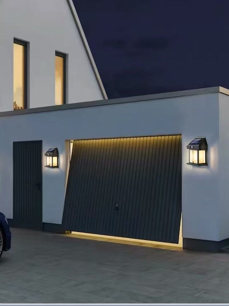 Two wall lanterns beside a garage door