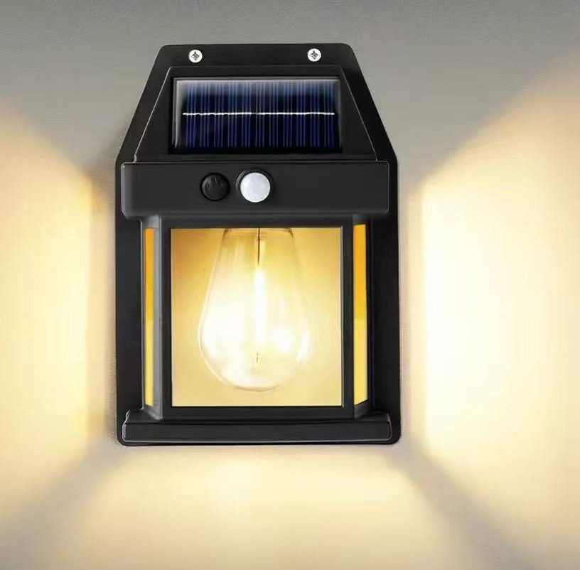 RENYI solar wall lantern with a vintage bulb glowing warm