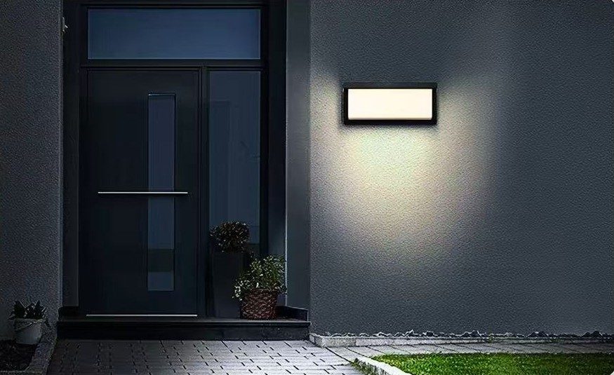 Wall light beside a front door at night