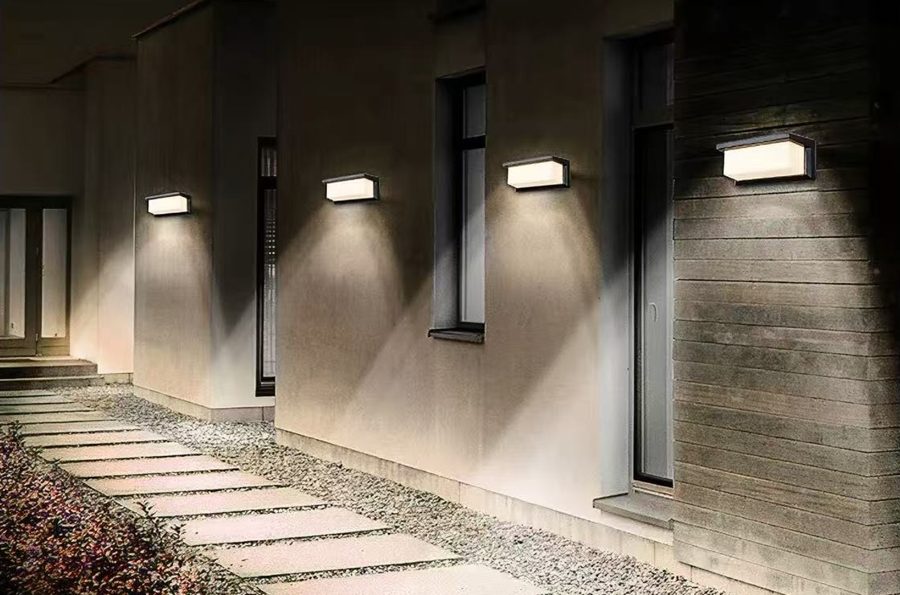 Solar motion-sensor wall lights mounted along a walkway