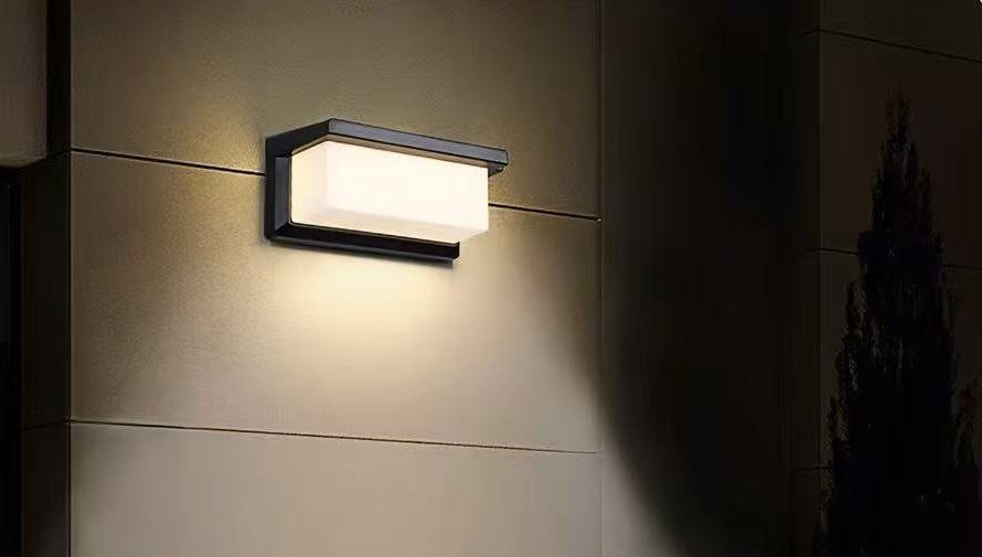 Wall light on a house wall at night
